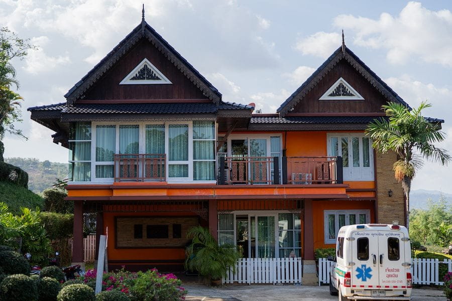 A house with a white truck parked in front named "Therapy Room 1", symbolizing a serene environment for rehab Thailand.