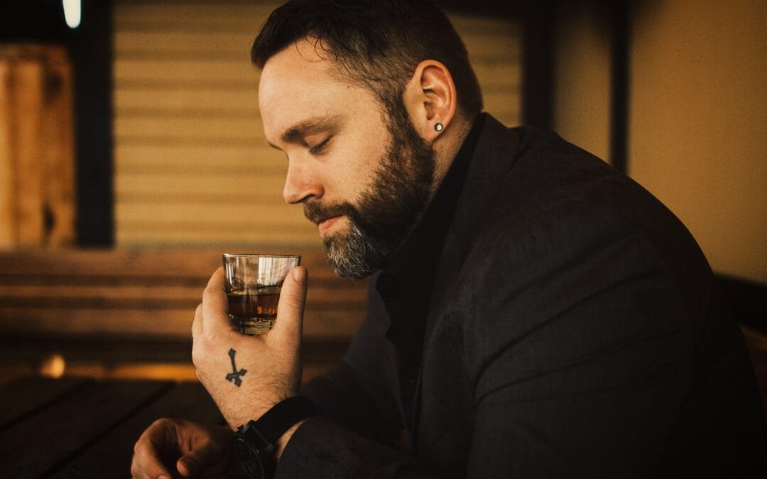 man holding a glass - What Is the First Step Toward Getting Treatment for Alcohol Addiction?